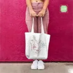 Χειροποίητη βαμβακερή tote τσάντα persona με κεντημένο σχέδιο αφαιρετικών προσώπων και λουλουδιών, με φερμουάρ.
